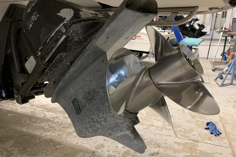 Slide: The Image of Close-up of a 2007 Cobalt 262 boat propeller in a workshop setting. - 34