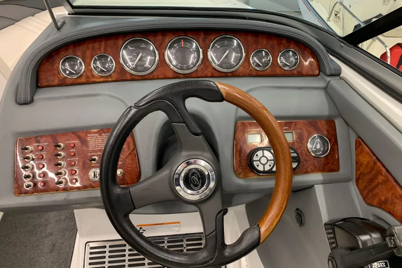 Slide: The Image of Dashboard of a 2007 Cobalt 262 boat with wood accents and gauges. - 8