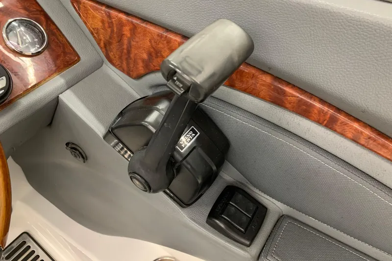 Slide: The Image of Boat throttle control in a 2007 Cobalt 262 with wood trim accents. - 9