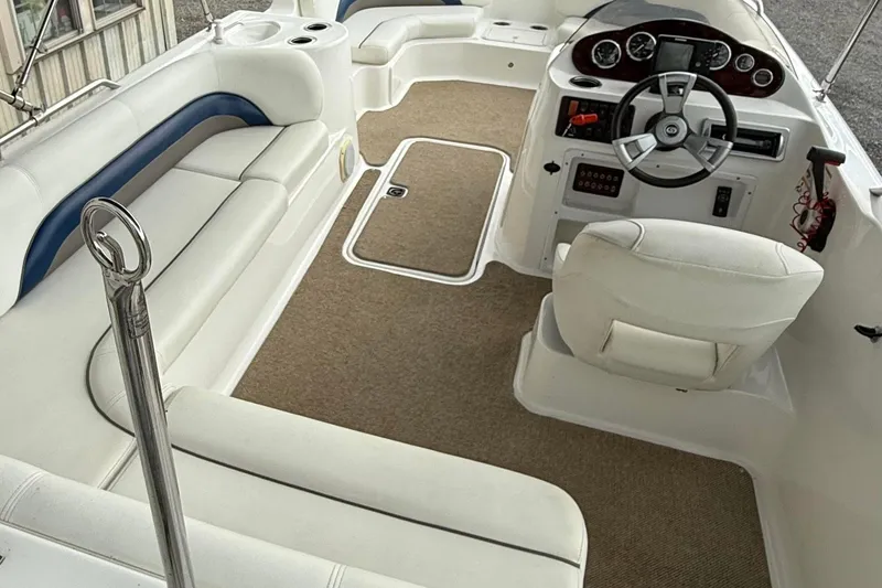 Slide: The Image of 2013 Hurricane SunDeck Sport 201 OB boat interior with white seating and steering console. - 5