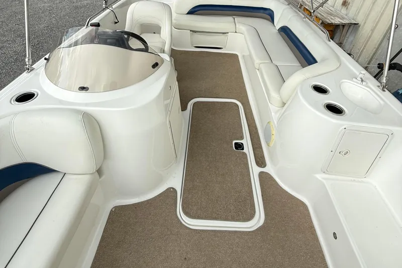 Slide: The Image of 2013 Hurricane SunDeck Sport 201 OB interior with white seating and beige flooring. - 8