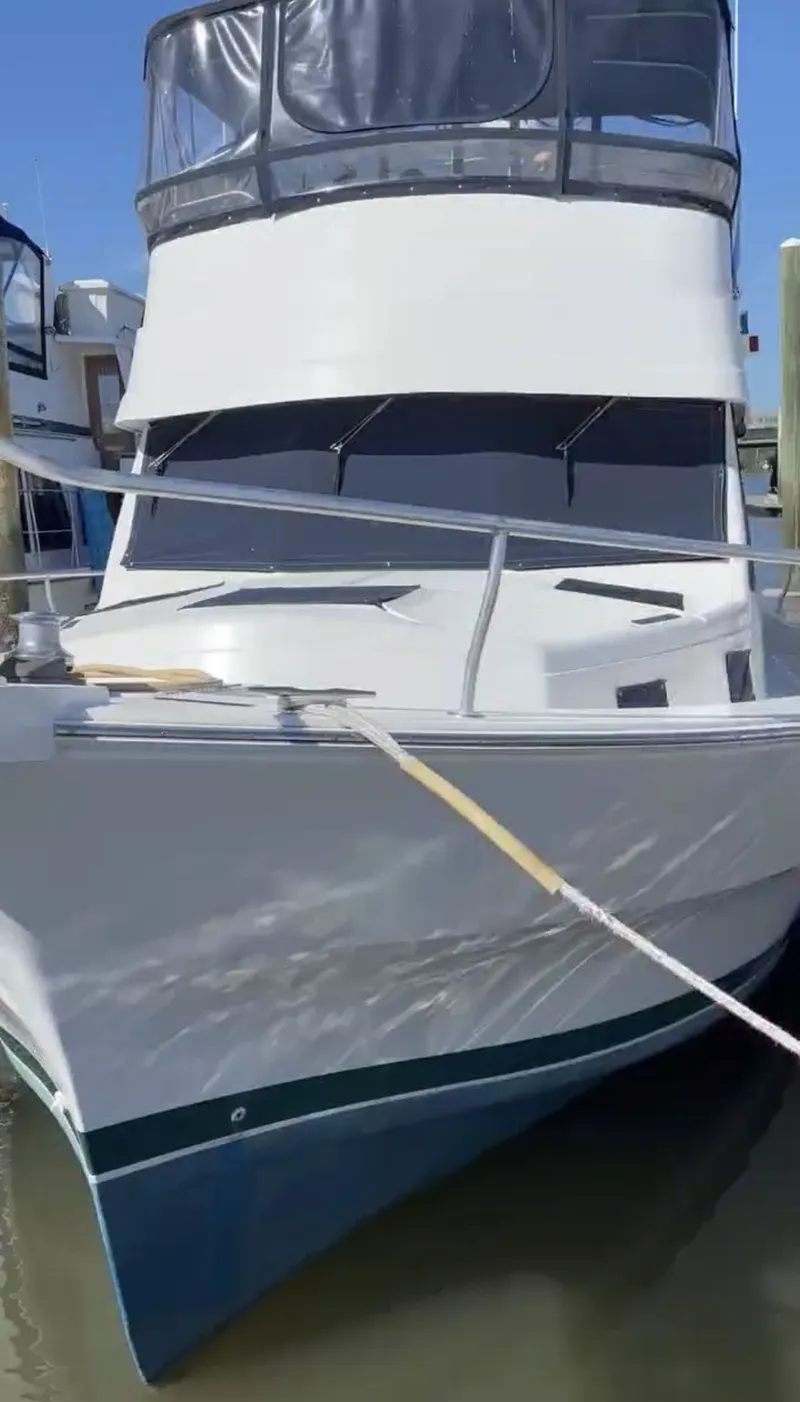 Slide: The Image of 2001 Mainship 390 Trawler docked, front view. - 10