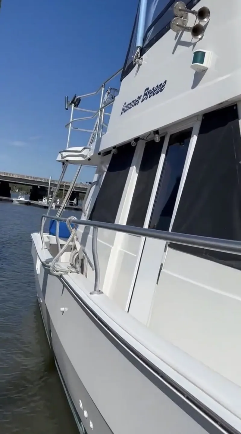 Slide: The Image of 2001 Mainship 390 Trawler docked, side view. - 12