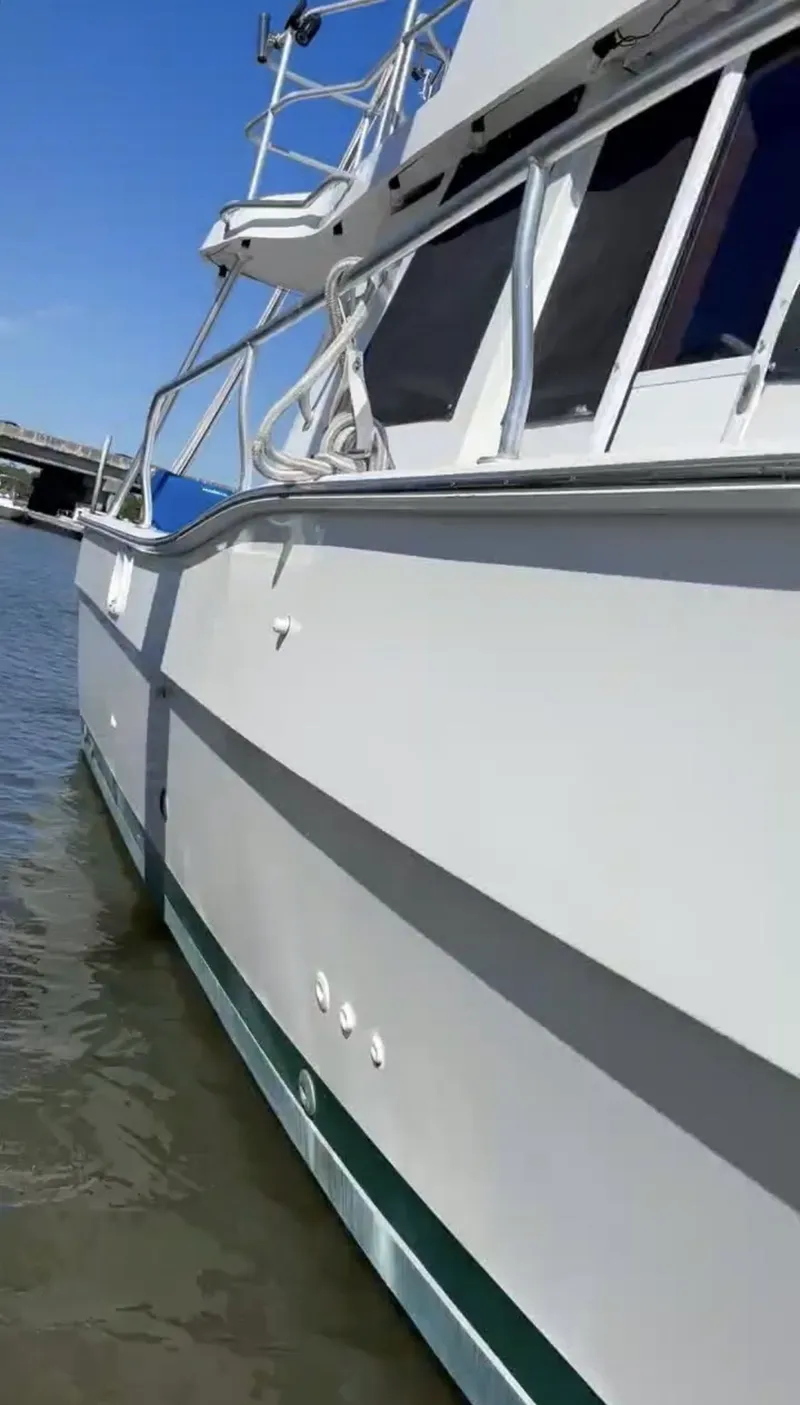 Slide: The Image of 2001 Mainship 390 Trawler on water, side view. - 14