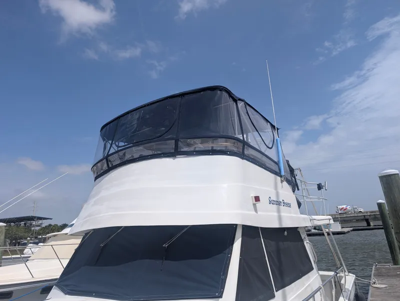 Slide: The Image of 2001 Mainship 390 Trawler docked under blue sky. - 15
