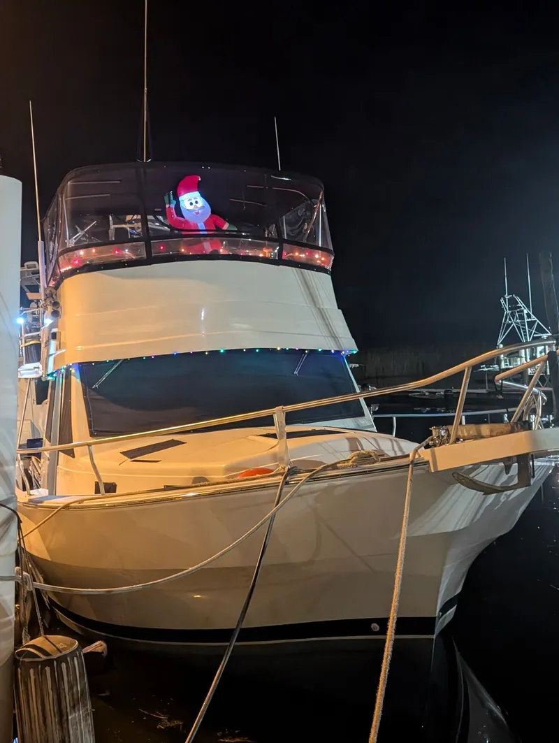 Slide: The Image of 2001 Mainship 390 Trawler with Christmas decorations docked at night. - 2