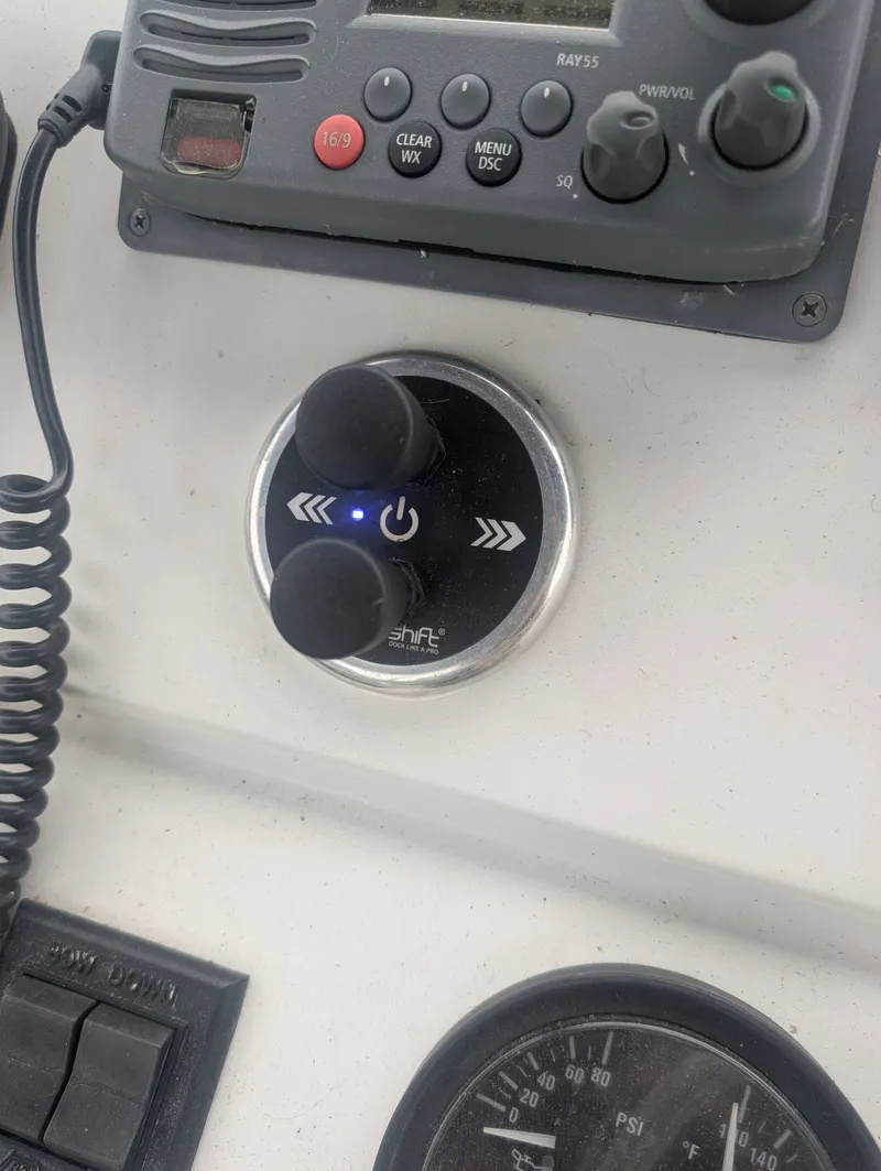 Slide: The Image of Control panel of a 2001 Mainship 390 Trawler with controls. - 29