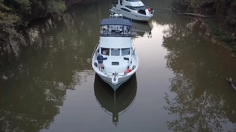 Slide: The Image of 2001 Mainship 390 Trawler on calm river, aerial view. - 4