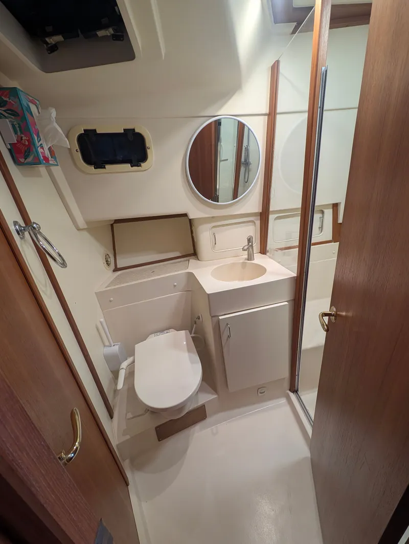 Slide: The Image of Bathroom in 2001 Mainship 390 Trawler with mirror and sink. - 44