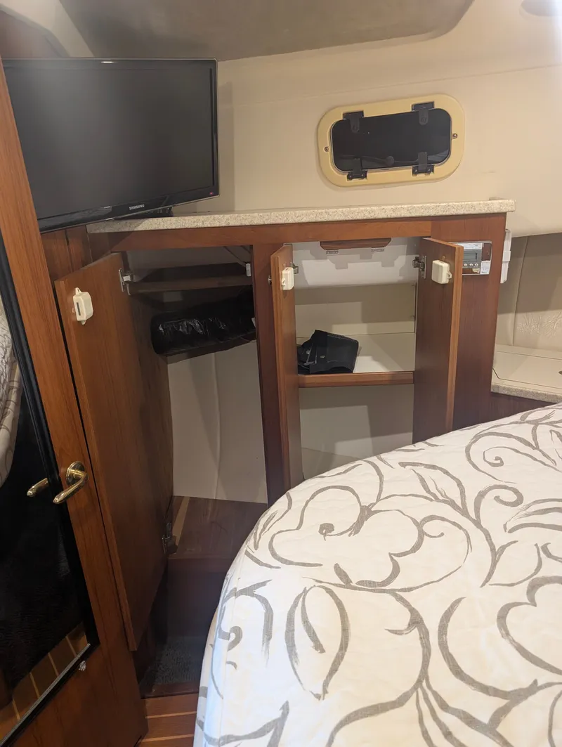 Slide: The Image of Interior of 2001 Mainship 390 Trawler with cabinet and TV. - 59