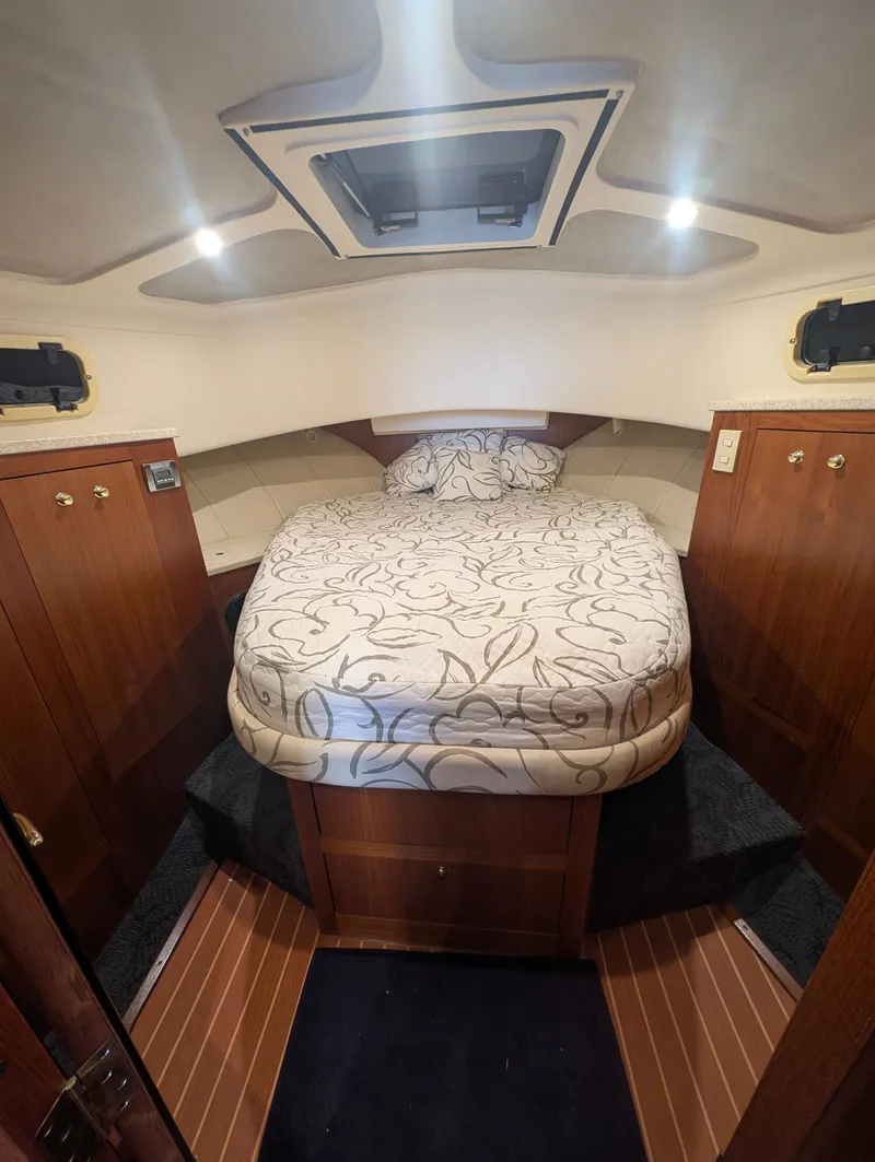 Slide: The Image of Interior of a 2001 Mainship 390 Trawler cabin with double bed. - 60