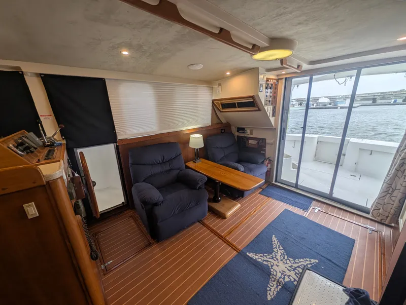 Slide: The Image of Interior of a 2001 Mainship 390 Trawler with cozy chairs and sea view. - 69