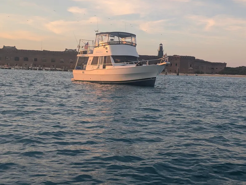 Slide: The Image of 2001 Mainship 390 Trawler near historic fort on the water. - 8