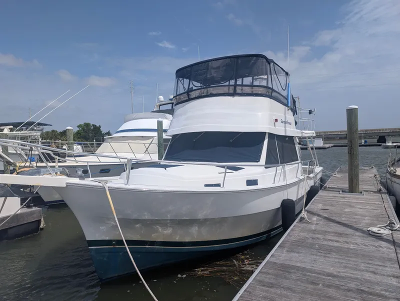 Slide: The Image of 2001 Mainship 390 Trawler docked on a sunny day. - 9