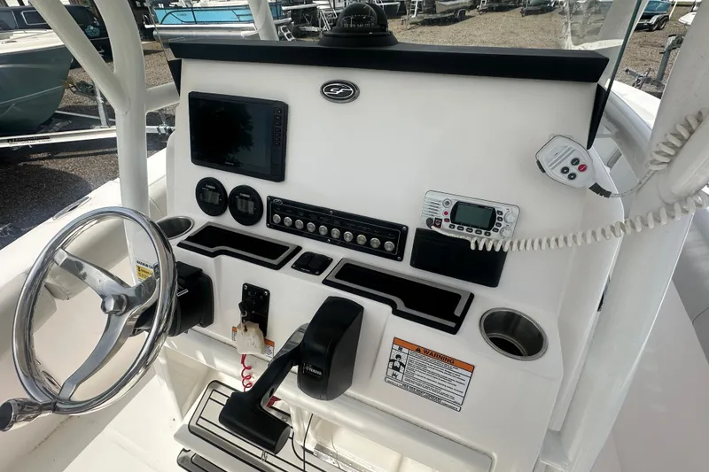 Slide: The Image of 2023 Sea Fox 228 Commander boat dashboard with steering wheel and electronic controls. - 10