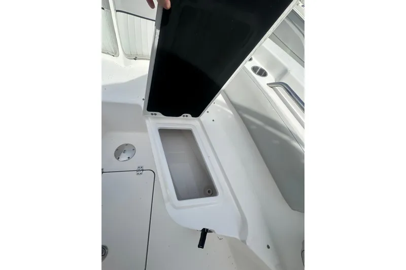 Slide: The Image of 2023 Sea Fox 228 Commander boat storage compartment open, showcasing interior space. - 18