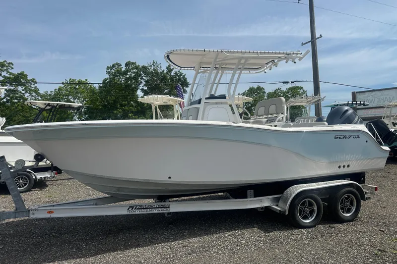 Slide: The Image of 2023 Sea Fox 228 Commander boat on trailer, parked outdoors. - 2