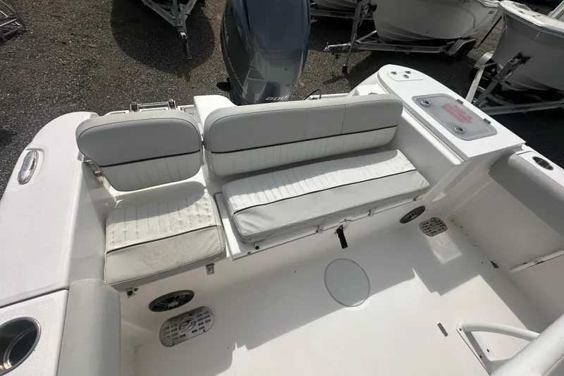 Slide: The Image of 2023 Sea Fox 228 Commander boat interior with white seating and storage compartments. - 22