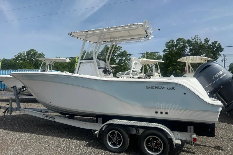 Slide: The Image of 2023 Sea Fox 228 Commander boat on trailer, side view, outdoors. - 3