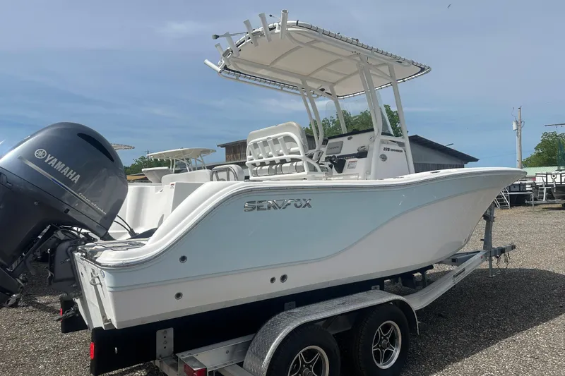 Slide: The Image of 2023 Sea Fox 228 Commander boat on trailer with Yamaha engine, parked outdoors. - 6