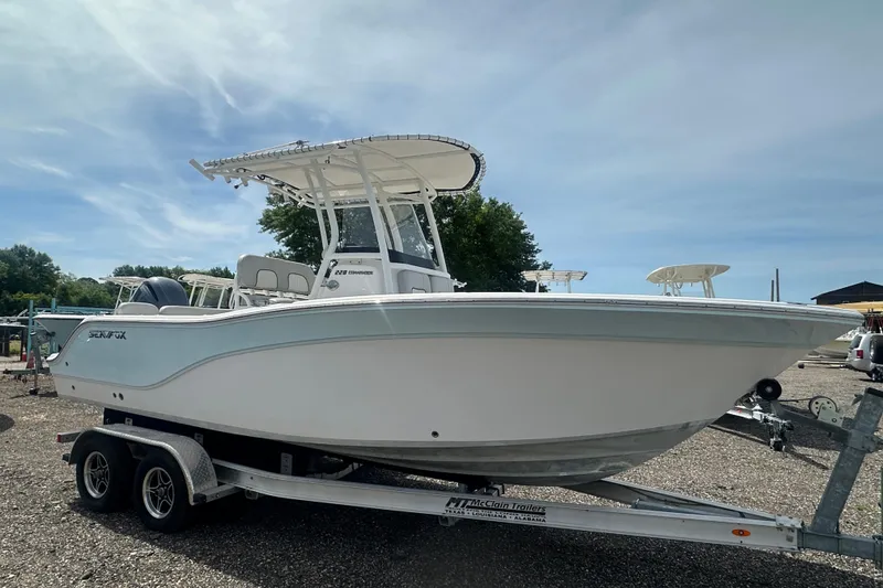 Slide: The Image of 2023 Sea Fox 228 Commander boat on trailer under clear sky. - 7