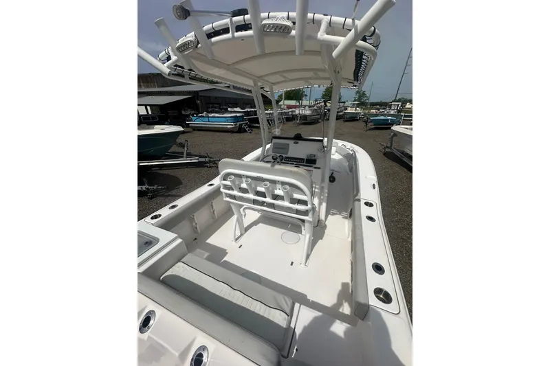 Slide: The Image of 2023 Sea Fox 228 Commander boat interior with seating and console, docked outdoors. - 9