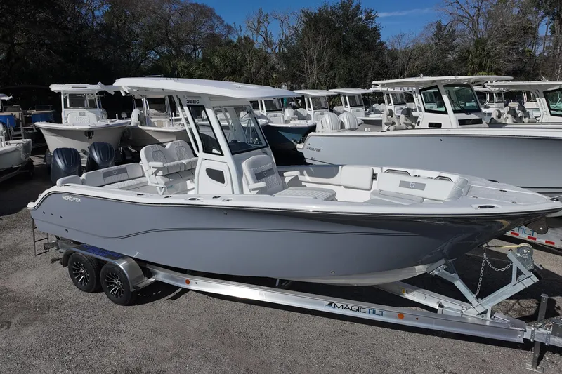 The Image of 2026 Sea Fox 268 Commander boat on trailer, parked outdoors with other boats. - 0