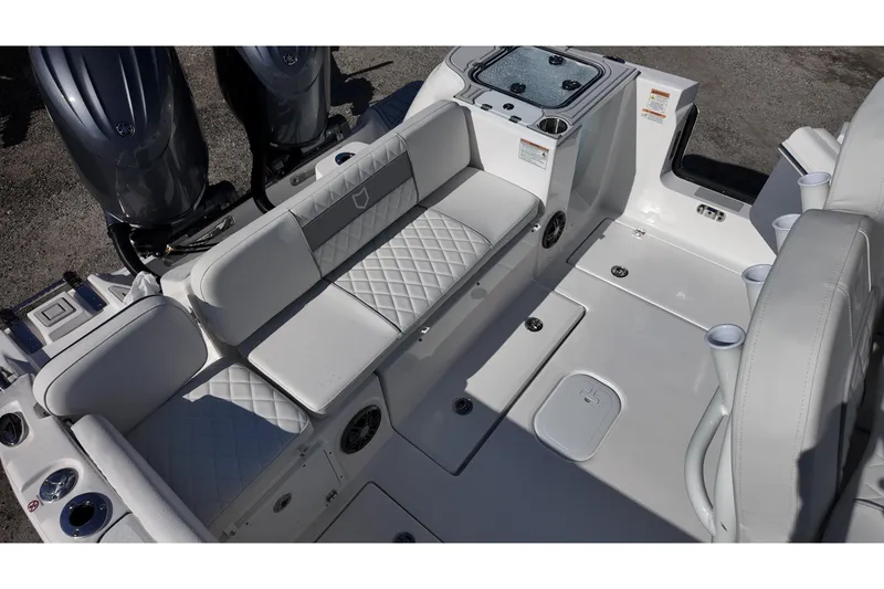 Slide: The Image of 2026 Sea Fox 268 Commander boat interior with cushioned seating and dual engines. - 14