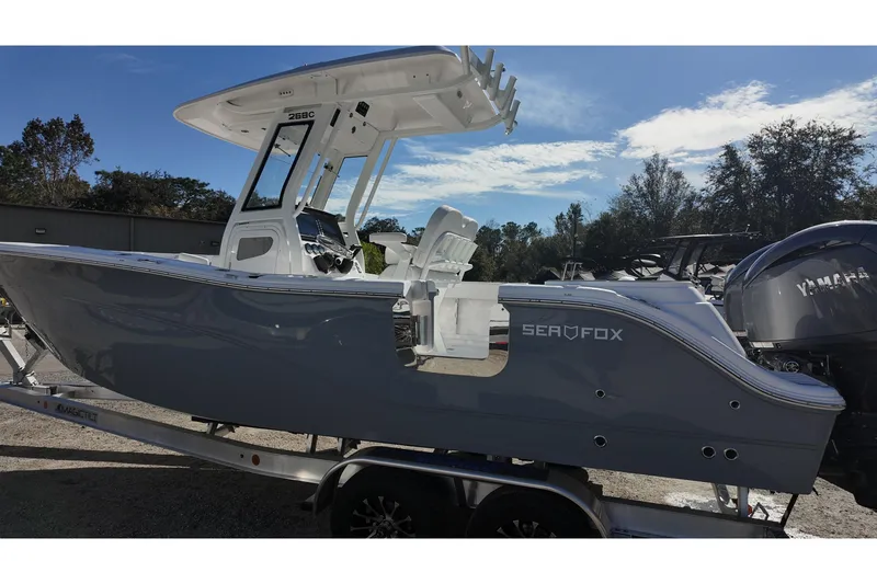Slide: The Image of 2026 Sea Fox 268 Commander boat on trailer, side view under clear sky. - 16