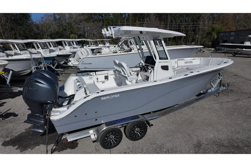 Slide: The Image of 2026 Sea Fox 268 Commander boat on trailer, parked in a marina. - 2