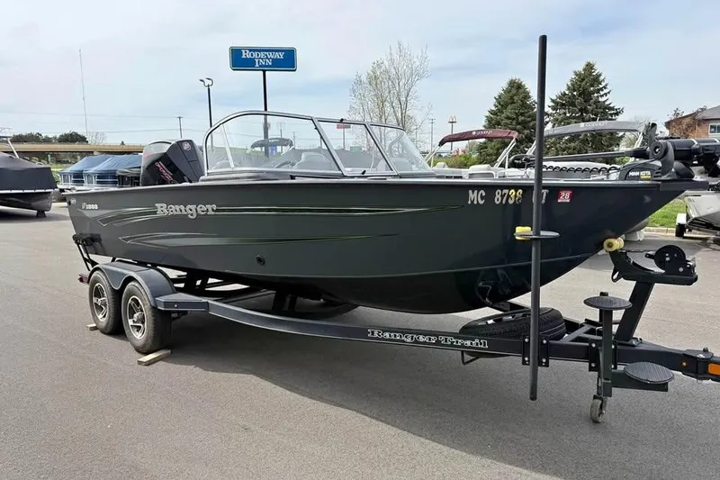 Slide: The Image of 2022 Ranger VX1888 WT boat on trailer, parked near Rodeway Inn. - 2