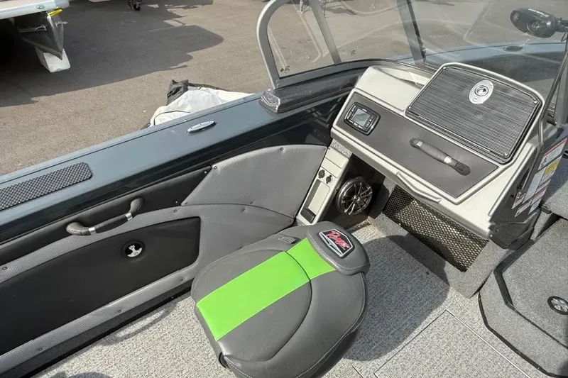 Slide: The Image of 2022 Ranger VX1888 WT boat interior with green-accented seat and dashboard controls. - 8