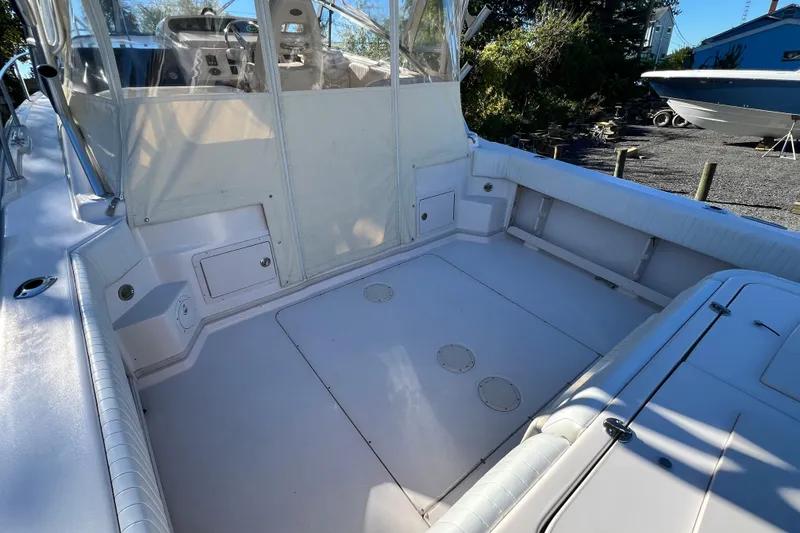 Slide: The Image of 2004 Grady-White Express 330 boat cockpit with seating and storage compartments. - 10