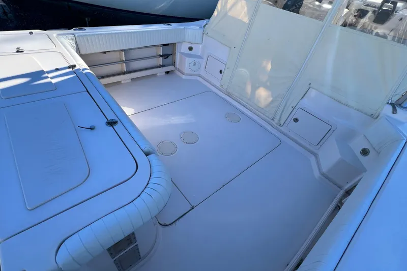 Slide: The Image of 2004 Grady-White Express 330 boat deck with seating and storage compartments. - 11