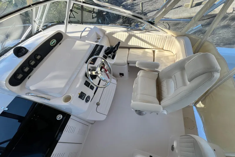 Slide: The Image of 2004 Grady-White Express 330 boat cockpit with steering wheel and seating. - 12