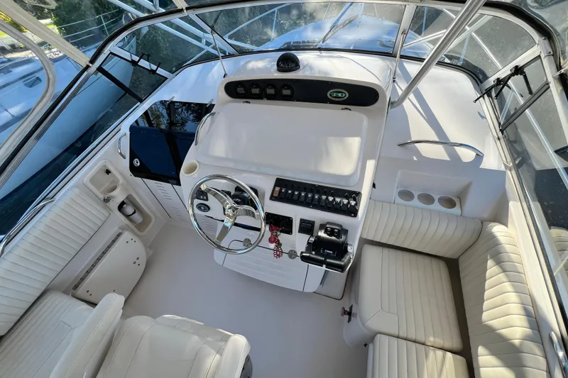 Slide: The Image of 2004 Grady-White Express 330 helm with steering wheel, controls, and seating. - 14