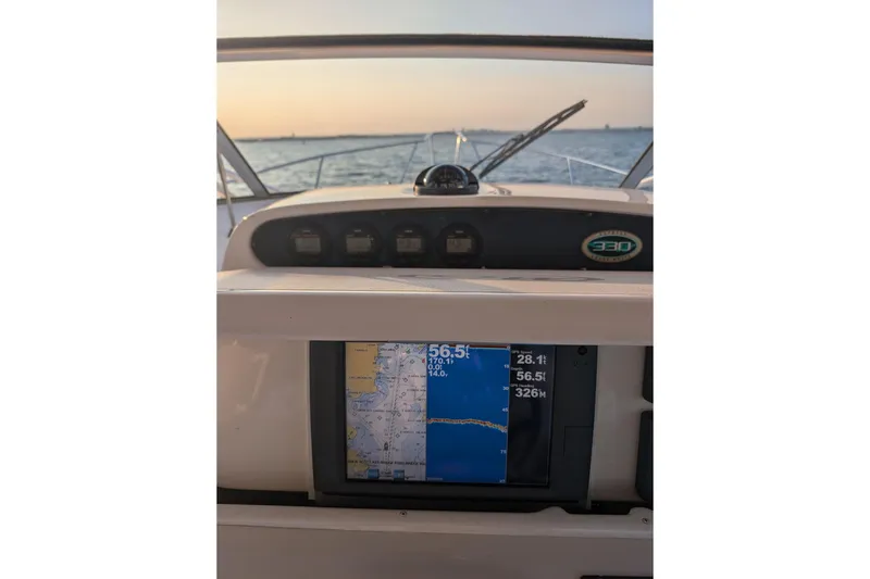Slide: The Image of Dashboard of a 2004 Grady-White Express 330 boat with navigation display. - 16