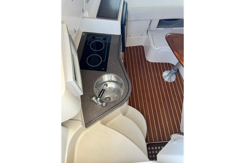 Slide: The Image of 2004 Grady-White Express 330 boat interior with kitchenette and wooden flooring. - 17