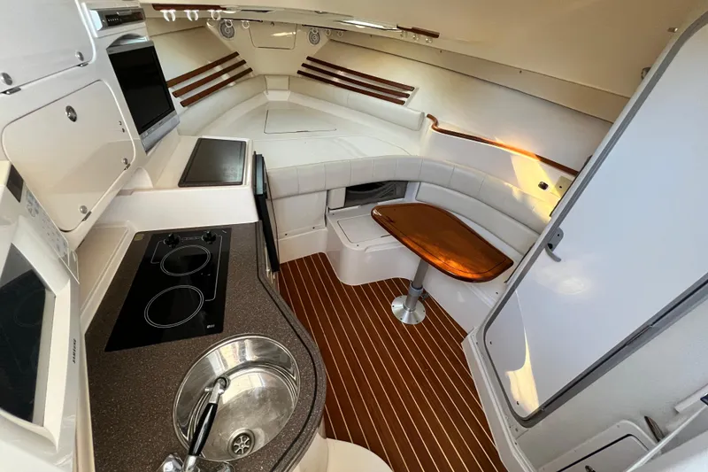 Slide: The Image of Interior of 2004 Grady-White Express 330 boat with kitchen and seating area. - 18