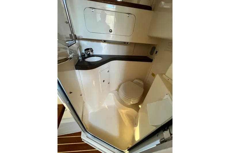 Slide: The Image of 2004 Grady-White Express 330 boat bathroom with sink and toilet. - 23