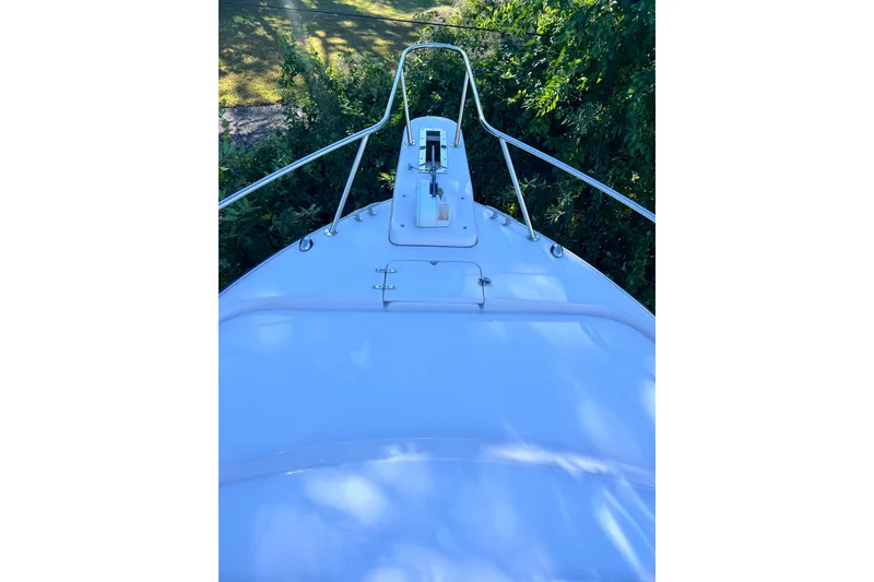 Slide: The Image of Bow view of 2004 Grady-White Express 330 boat surrounded by greenery. - 26