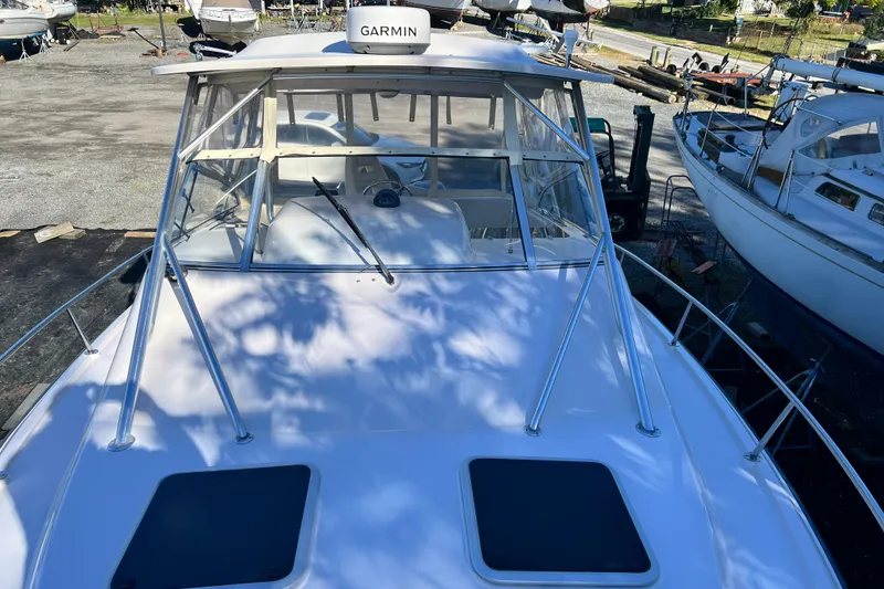 Slide: The Image of 2004 Grady-White Express 330 boat with Garmin equipment, docked among other vessels. - 27
