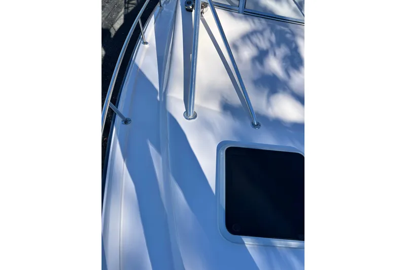 Slide: The Image of 2004 Grady-White Express 330 boat deck with railing and hatch. - 29