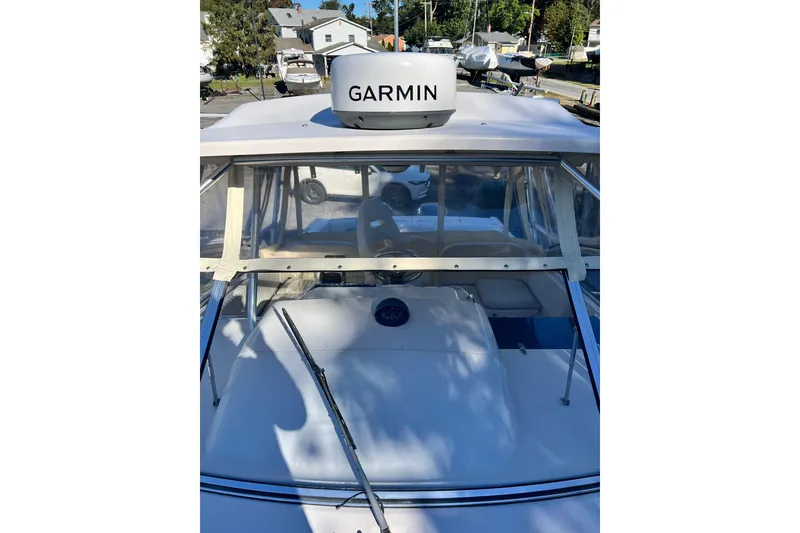 Slide: The Image of 2004 Grady-White Express 330 boat with Garmin radar, docked in a marina. - 30