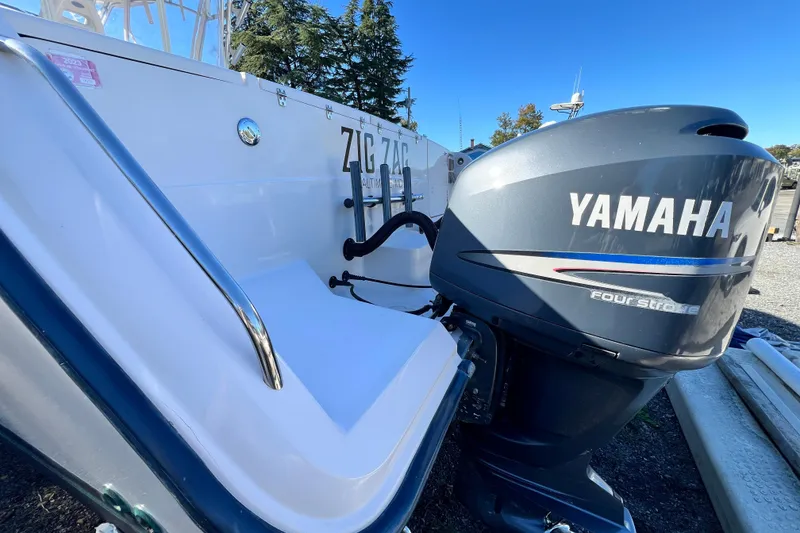 Slide: The Image of 2004 Grady-White Express 330 boat with Yamaha four-stroke engine, docked outdoors. - 36