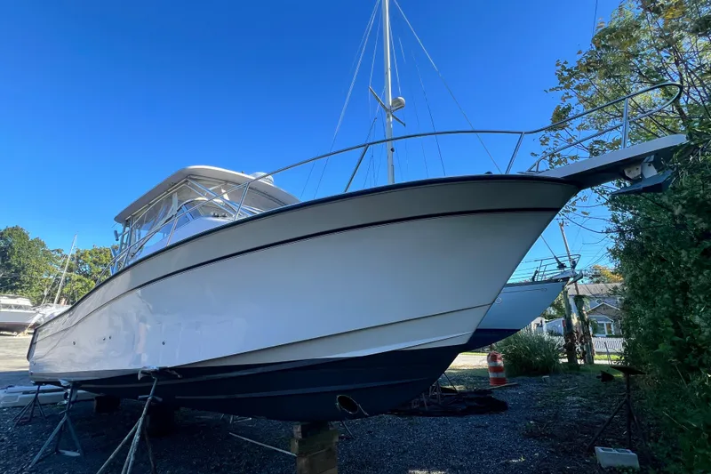 Slide: The Image of 2004 Grady-White Express 330 boat on land under clear blue sky. - 39