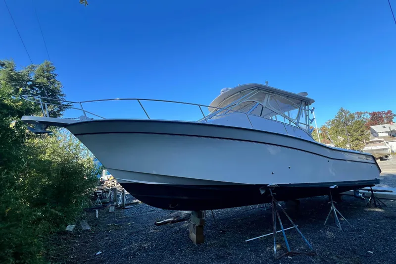 Slide: The Image of 2004 Grady-White Express 330 boat on stands, clear blue sky background. - 4