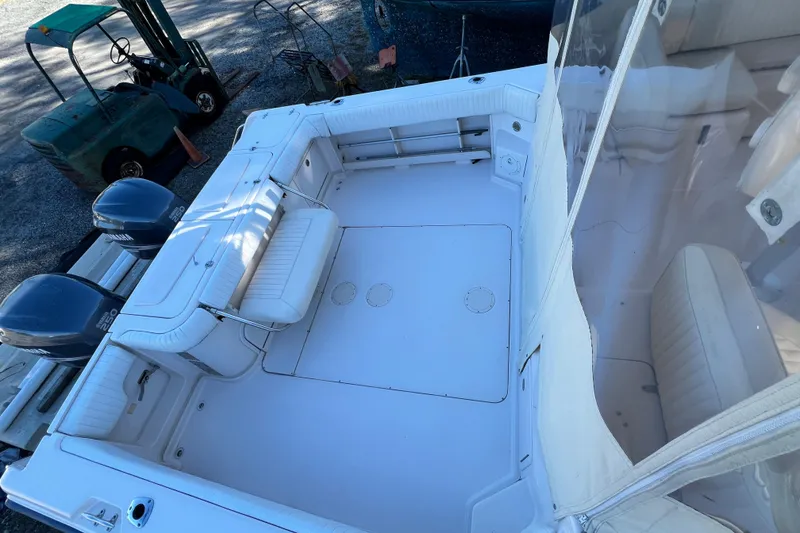 Slide: The Image of 2004 Grady-White Express 330 boat deck with seating and twin engines. - 9