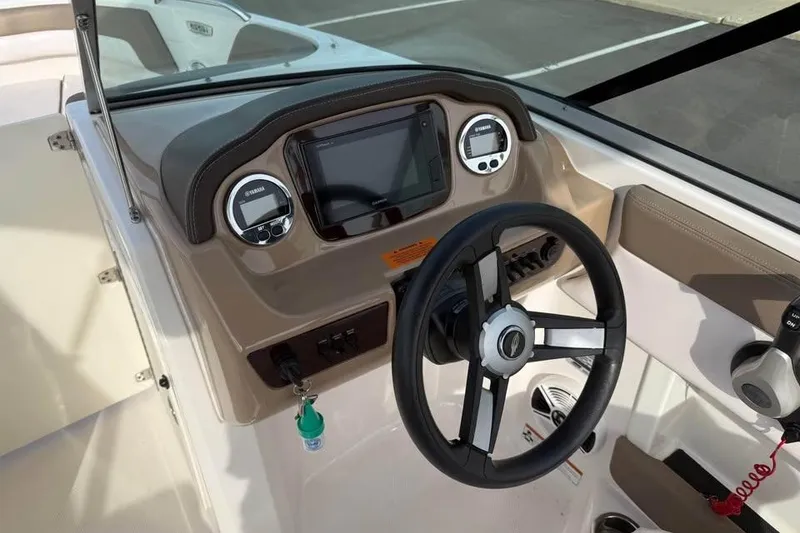 Slide: The Image of 2020 Chaparral 21 SSi OB boat dashboard with steering wheel and controls. - 11