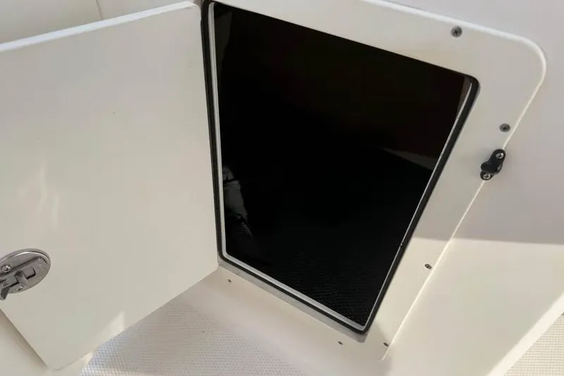 Slide: The Image of Open storage compartment on 2020 Chaparral 21 SSi OB boat. - 16